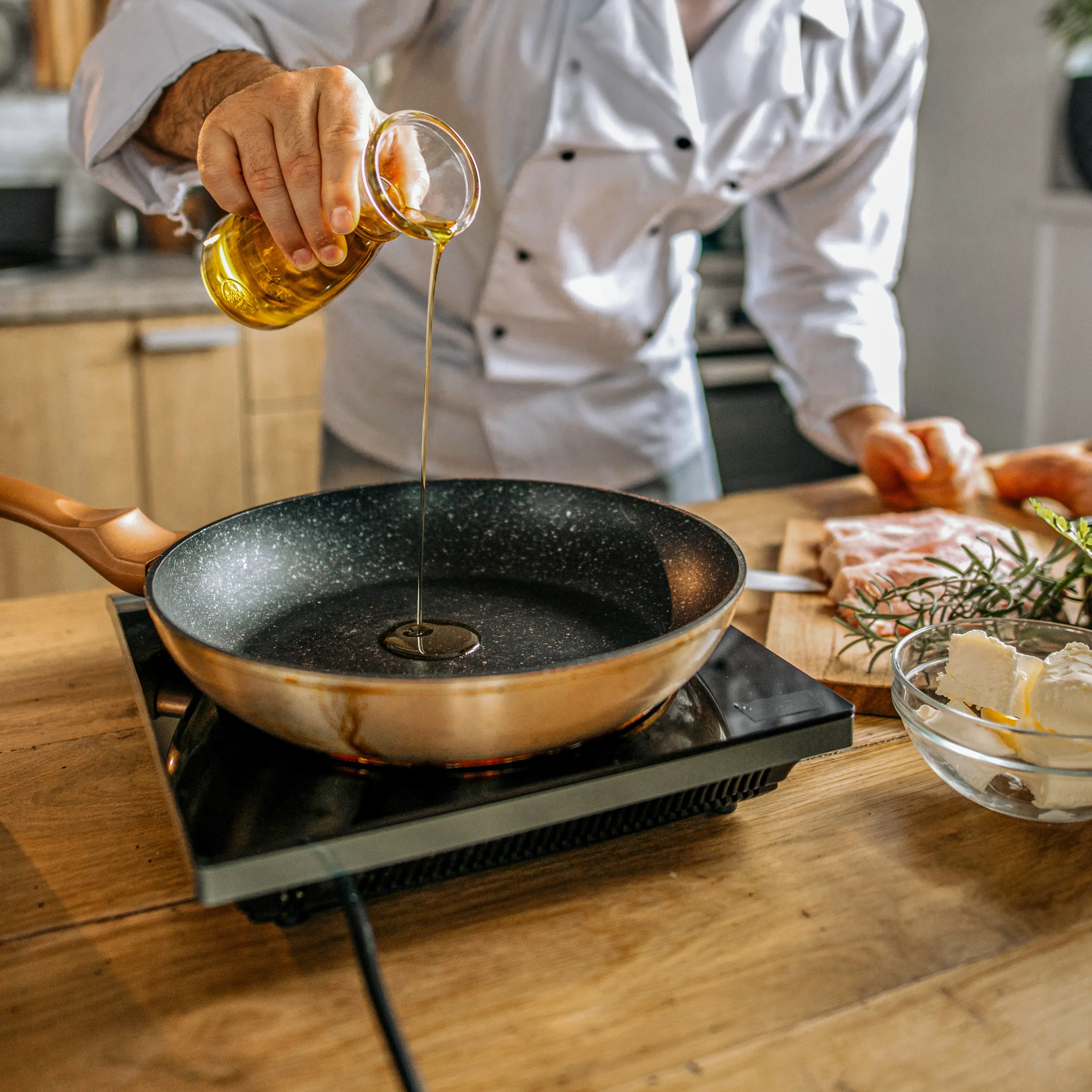 Person pouring soybean oil into a pan